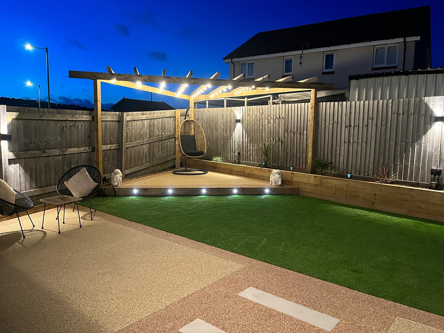 Photo from a full garden renovation project where we changed the fencing, laid astroturf, fitted a pergola, built flower beds, installed lights and installed a patio
