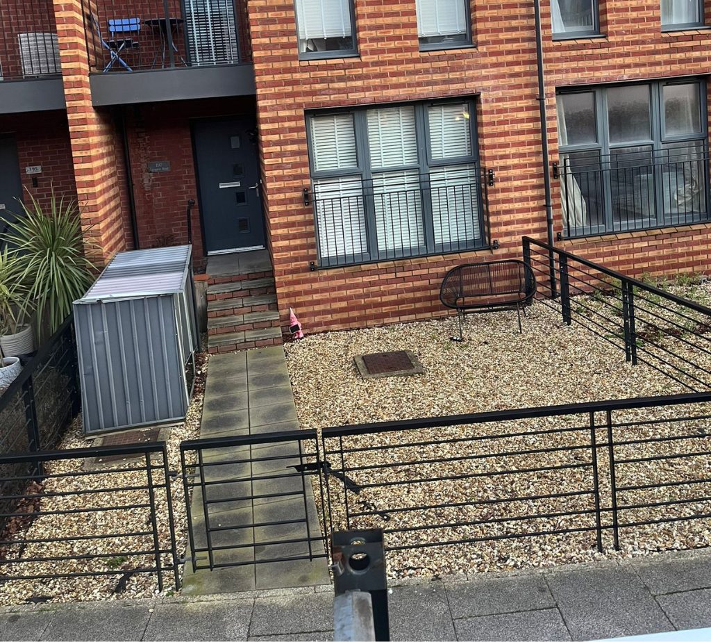 A before photo of a concrete slab path in Swansea